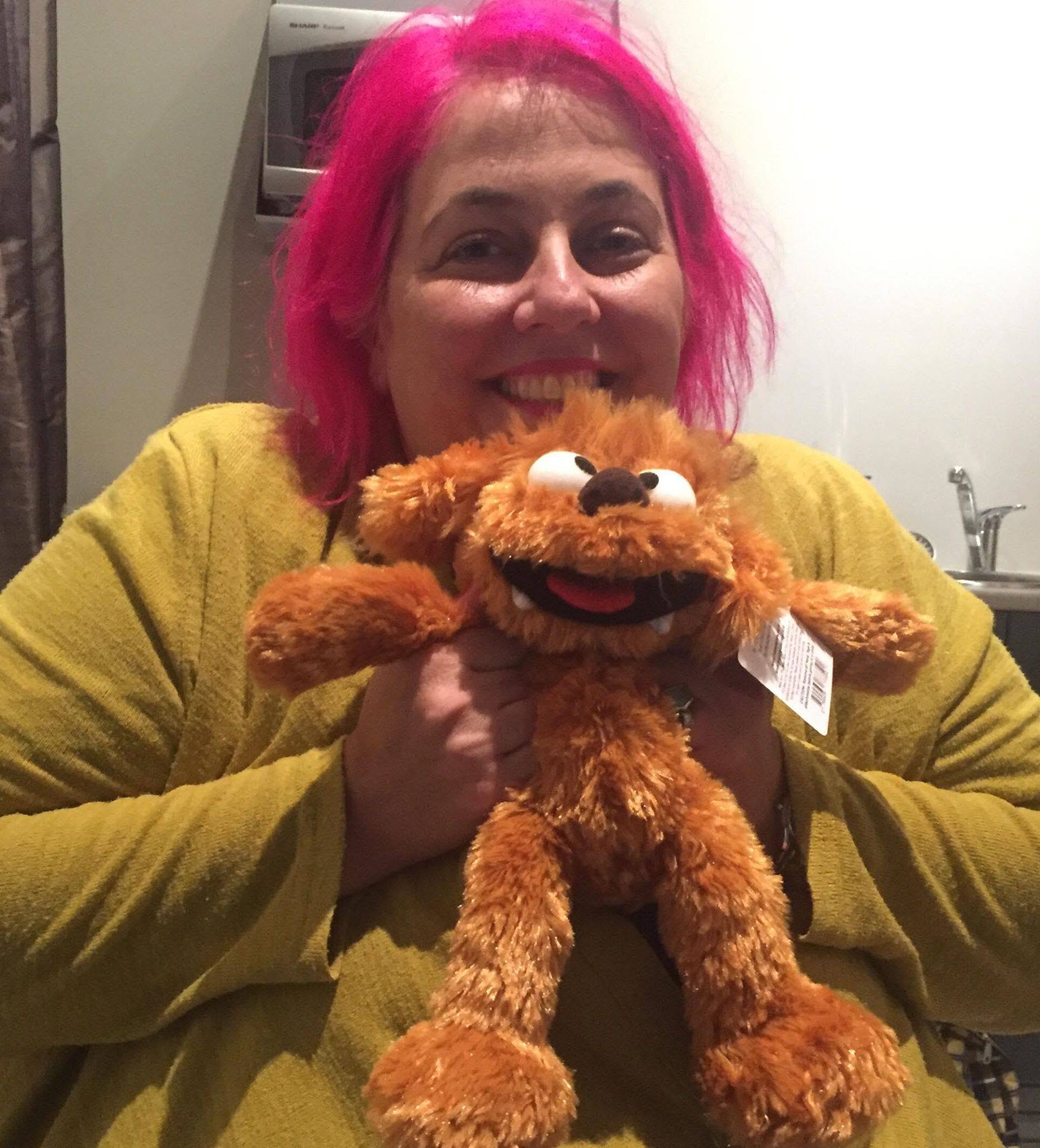 Elissa holding a stuffed Moe toy from The Moe Show given to her by New Zealand puppeteer Jeremy Dillon